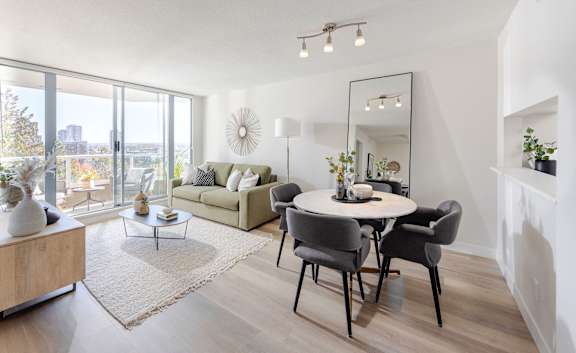 a living room with a round dining table and a couch
