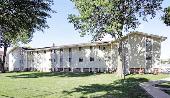 A large building with a green lawn in front. at Southern Hills Apartments, Marshalltown, IA, 50158
