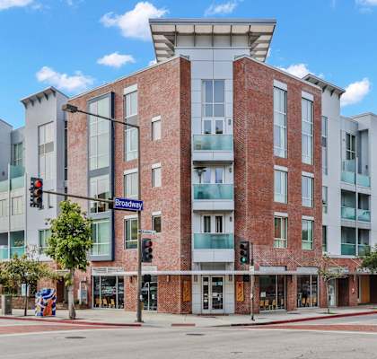 an apartment building on the corner of a city street