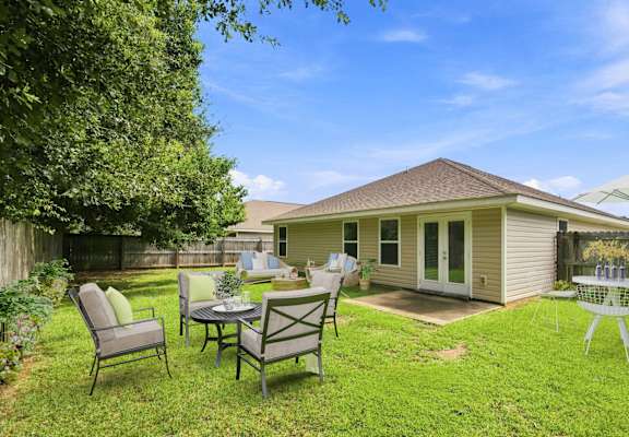 A backyard with a patio table set for four.