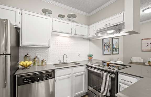 Bright kitchen with white cabinets and stainless-steel appliances 