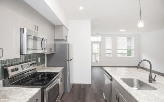 a kitchen with stainless steel appliances and island