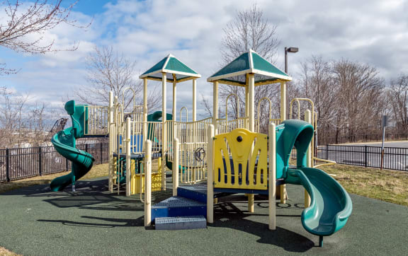 a playground with slides and other equipment in a park