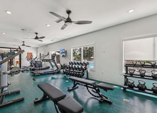 A well-equipped home gym with a variety of exercise equipment.