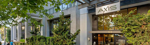 Axis sign on a building with a glass door entrance.