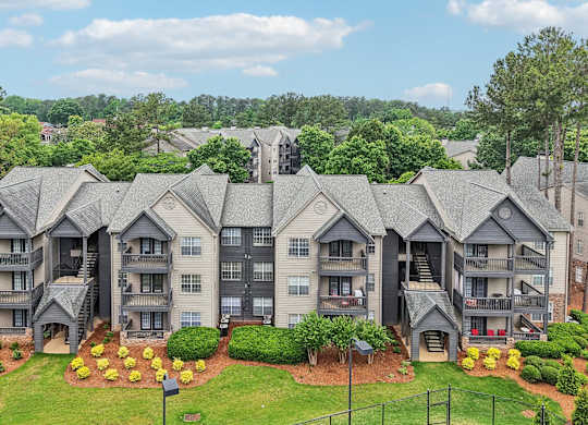 the Apartment complex with multiple buildings and landscaped gardens.