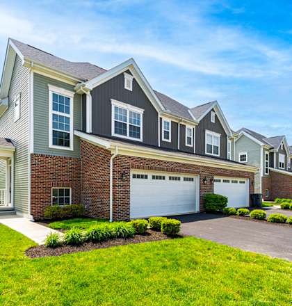 A row of houses with a clear blue sky above them.