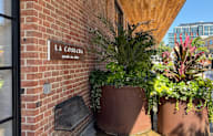 A sign on a brick wall that says "La Cosecha" is visible.