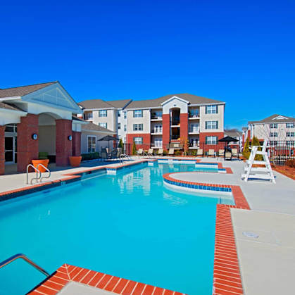 A swimming pool surrounded by a red brick border.