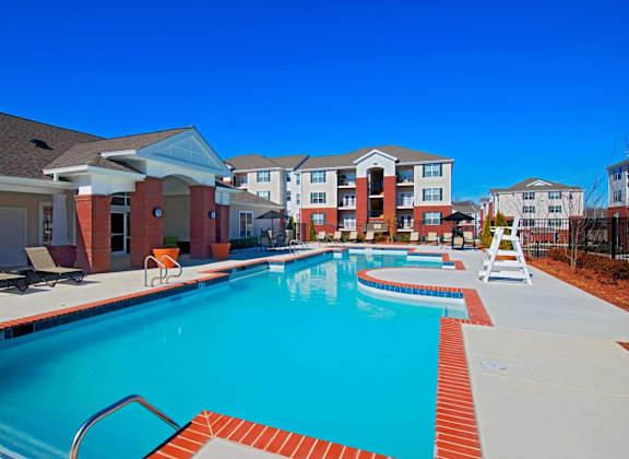 A swimming pool surrounded by a red brick border.