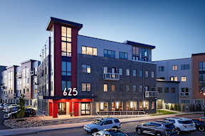 The building 625 is a modern multi-story residential building with a parking lot in front.