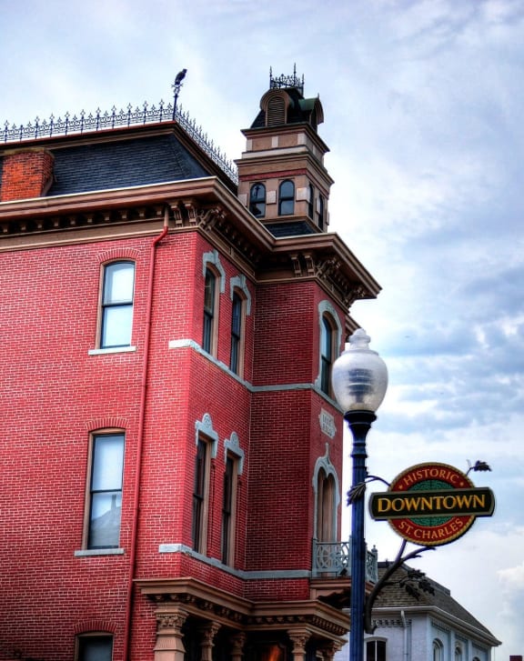 a red brick building with a sign for a dunkin donuts on the corner