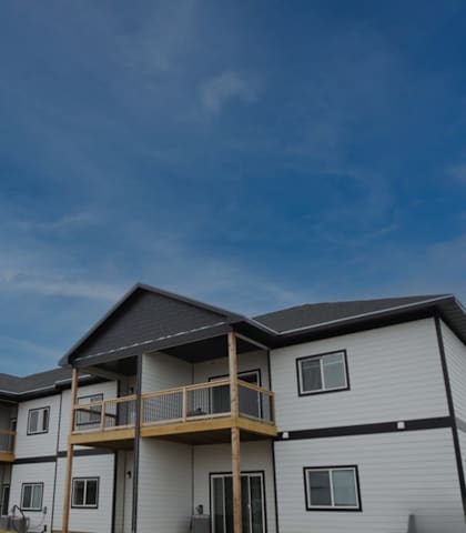 A row of houses with balconies and a clear sky.