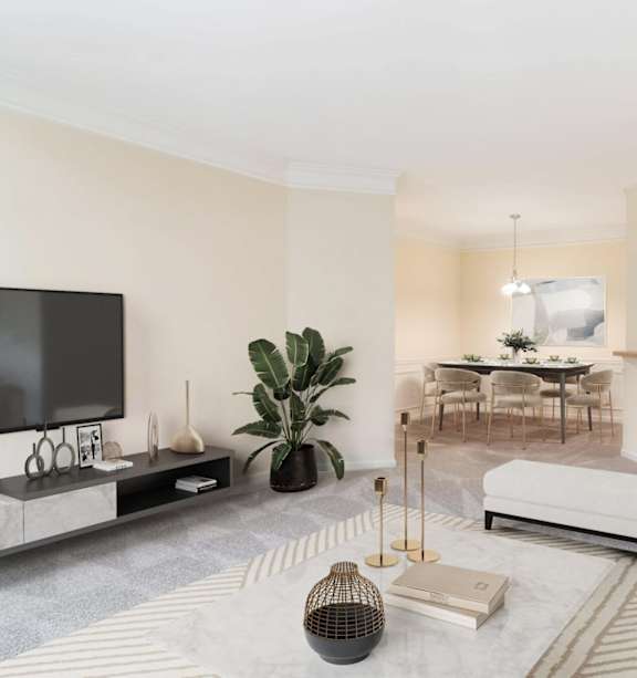 Spacious open-concept living room, dining area, and kitchen in an upscale apartment at Village at Almand Creek in Conyers, GA. Features modern furnishings, natural light, and elegant design.