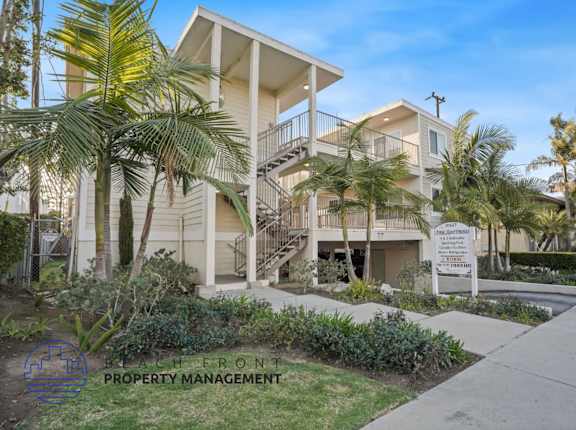 A building with a sign that says "South Front Property Management" in front of it.