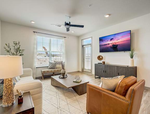 a living room with couches and chairs and a tv at Alta25, Monument, Colorado