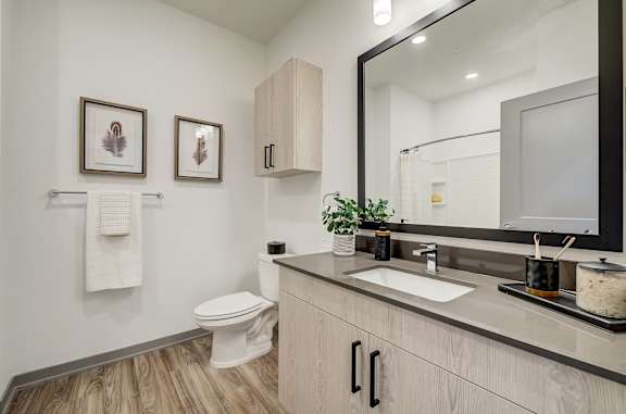 a bathroom with a sink and a toilet and a mirror at Alta25, Monument, Colorado