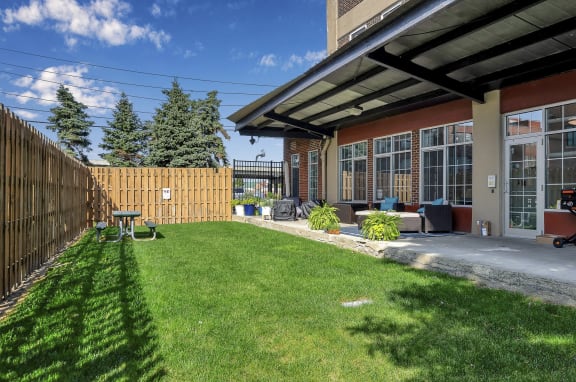 a backyard with a patio and a fence at The Lofts at Elk Terminal Apartments , New York