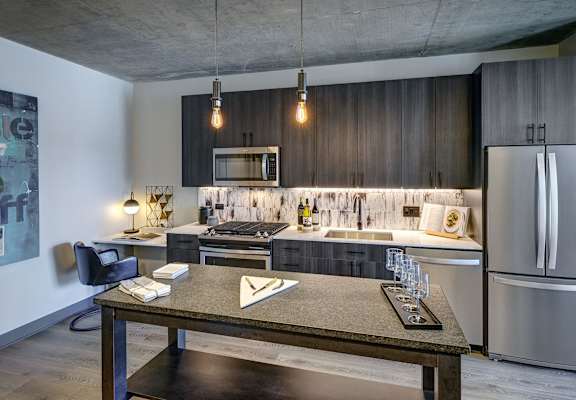 A modern kitchen with a dining table and chairs. at The Mason Apartments, Illinois, 60607