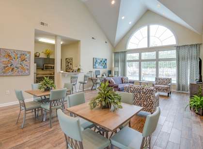 A dining room with a table and chairs.