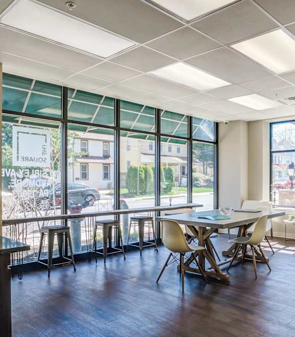 A conference room with a long table and chairs.