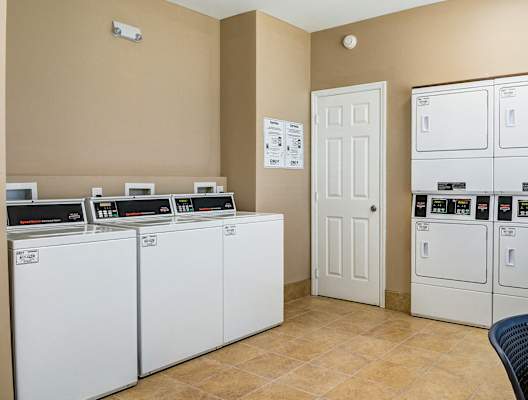 A laundry room with washers and dryers.