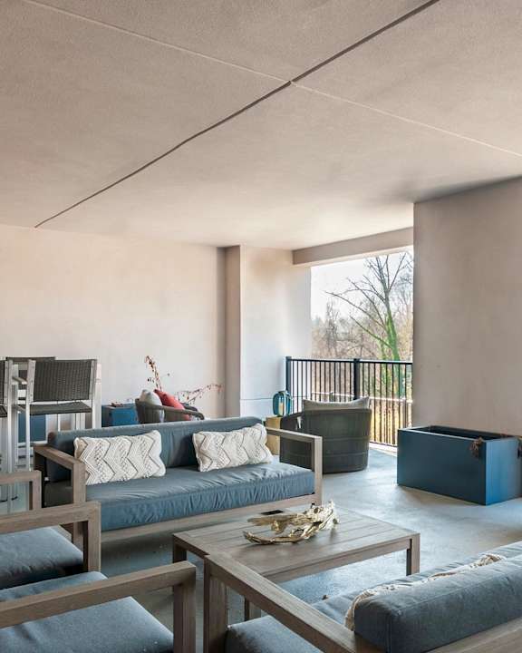 A modern living room with a large sofa and a coffee table.
