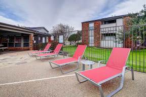 Lounge chairs by swimming pool