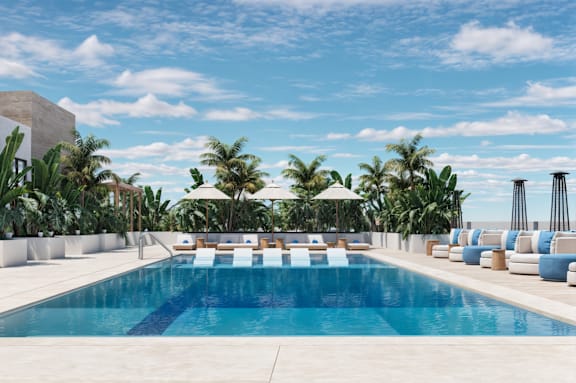 a swimming pool at a hotel with palm trees