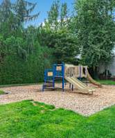 A playground with a blue slide and yellow slide.