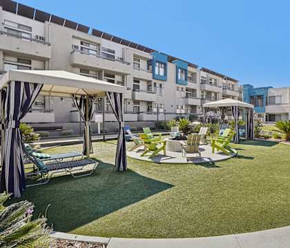 A sunny day at the outdoor seating area of a modern apartment complex.