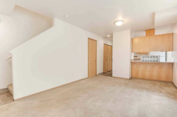 A room with a ceiling fan and a window with bars.