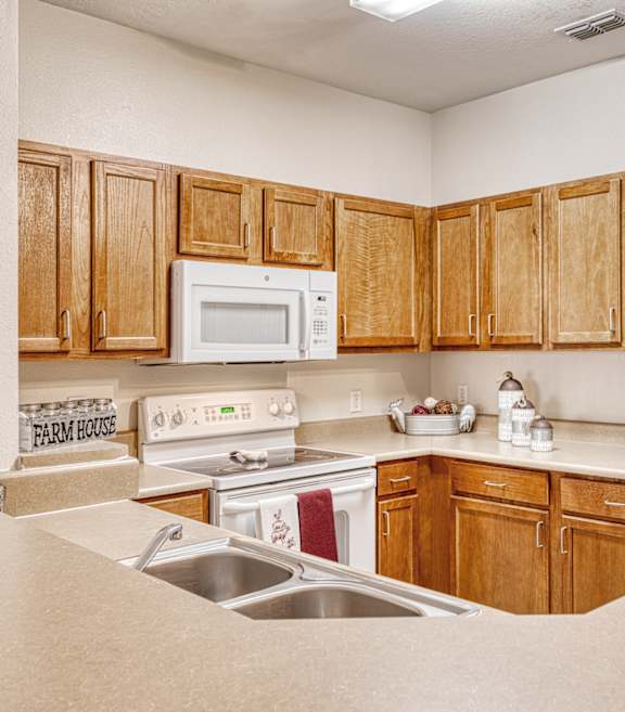 A kitchen with wooden cabinets and a white refrigerator.