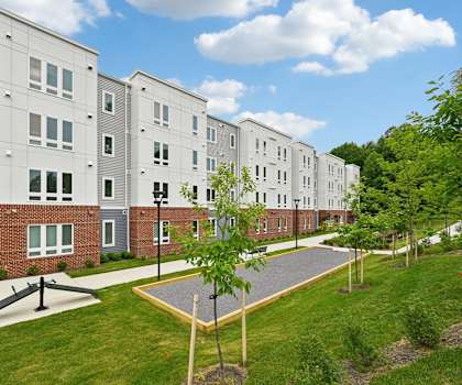 Apartment complex with a green lawn in front.