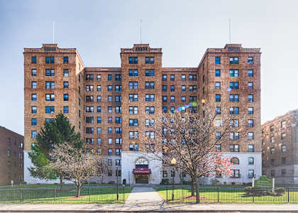 a large brick building with trees in front of it