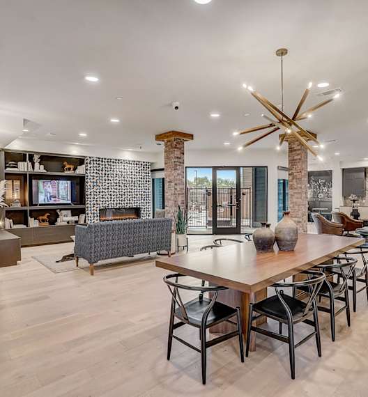A modern living room with a wooden table and chairs.