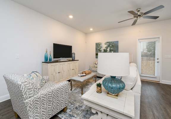 a living room with a white couch and a tv
