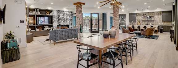 A modern living room with a wooden table and chairs.