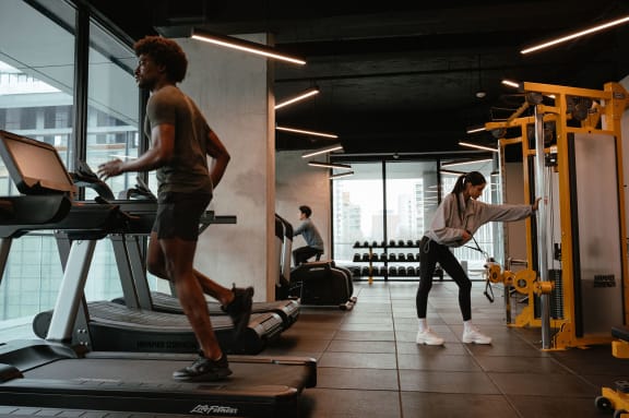 a woman lifting a dumbbell in a gym