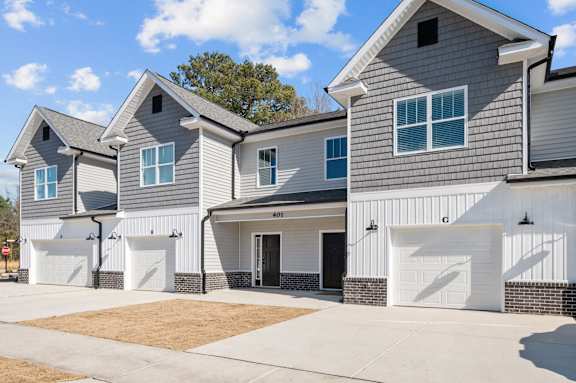 A modern two-story house with a garage on the lower level.at Regency Townes, North Carolina