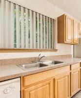 A kitchen with wooden cabinets and a white refrigerator.