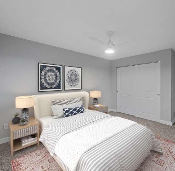 A bedroom with a large bed, a chandelier, and two nightstands with lamps. at Indian Creek Apartments, Cincinnati, OH, 45236