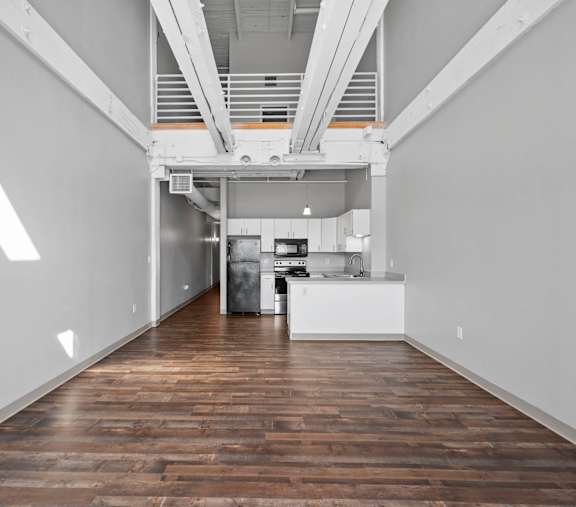A long hallway with a kitchen at the end.