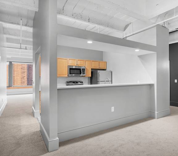 A kitchen area with a microwave and oven.at East 4th Street, Cleveland, OH