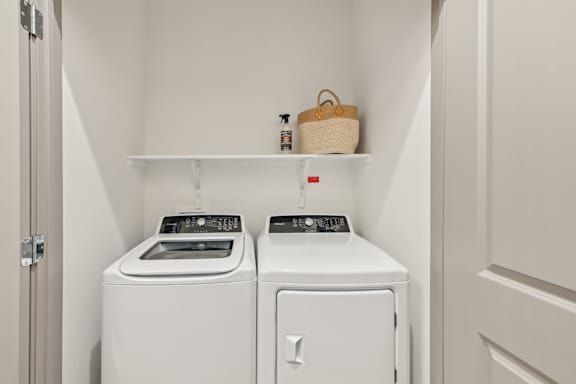 A small laundry room with a washer and dryer.