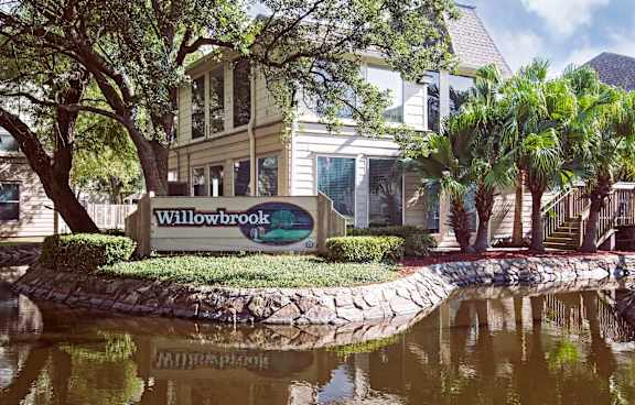 A sign that says Willowbrook in front of a building.