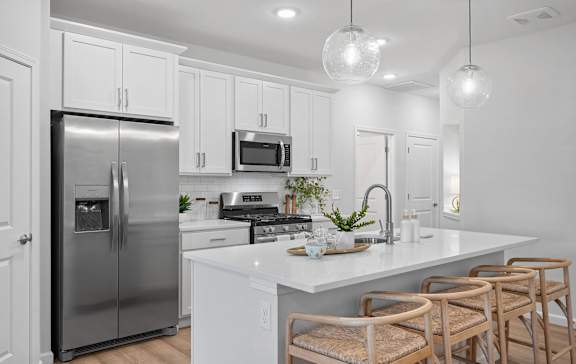 a view of a kitchen with a island and blue chairs