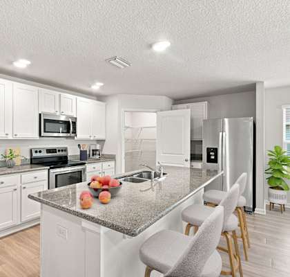 A kitchen with a granite countertop and white cabinets.