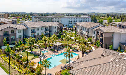 an aerial view of the resort style pool at the bradley braddock road station apartments