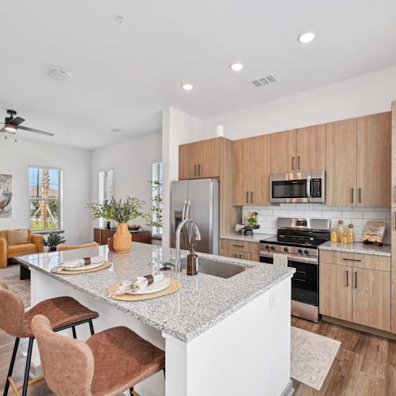 the kitchen is open to the living room and dining room at The Hadley Luxury Apartments, North Port, Florida